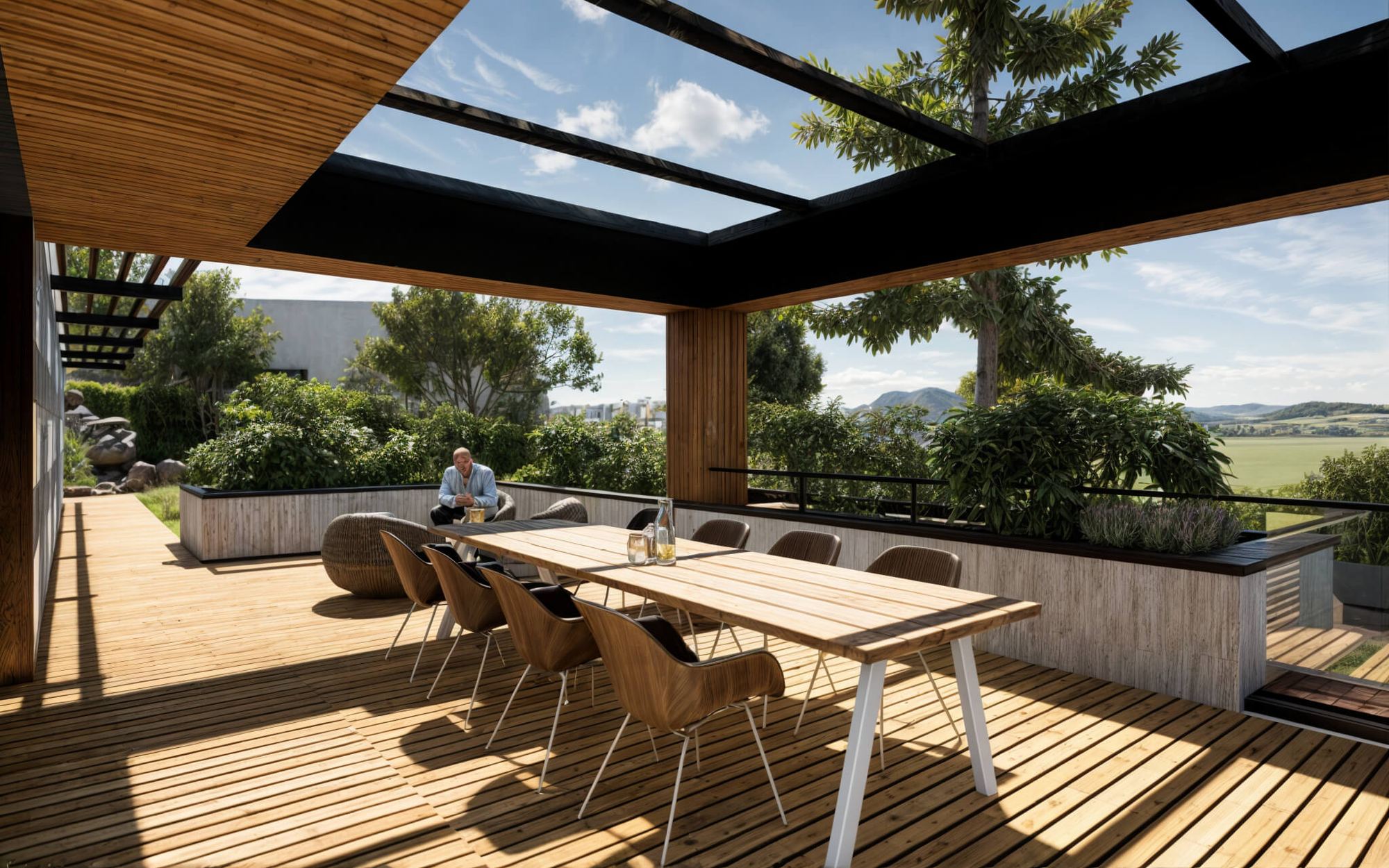 Terrazza in legno coperta di una casa interrata a Trnava, tavolo da pranzo sotto pergola vetrata, colline sullo sfondo.