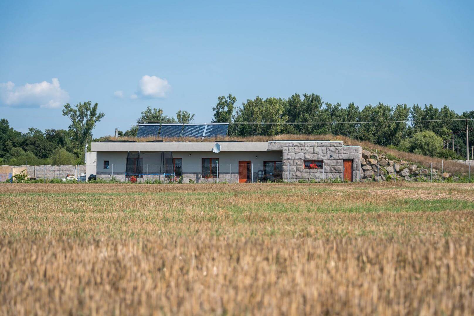 A house covered with earth on a flat plot of land